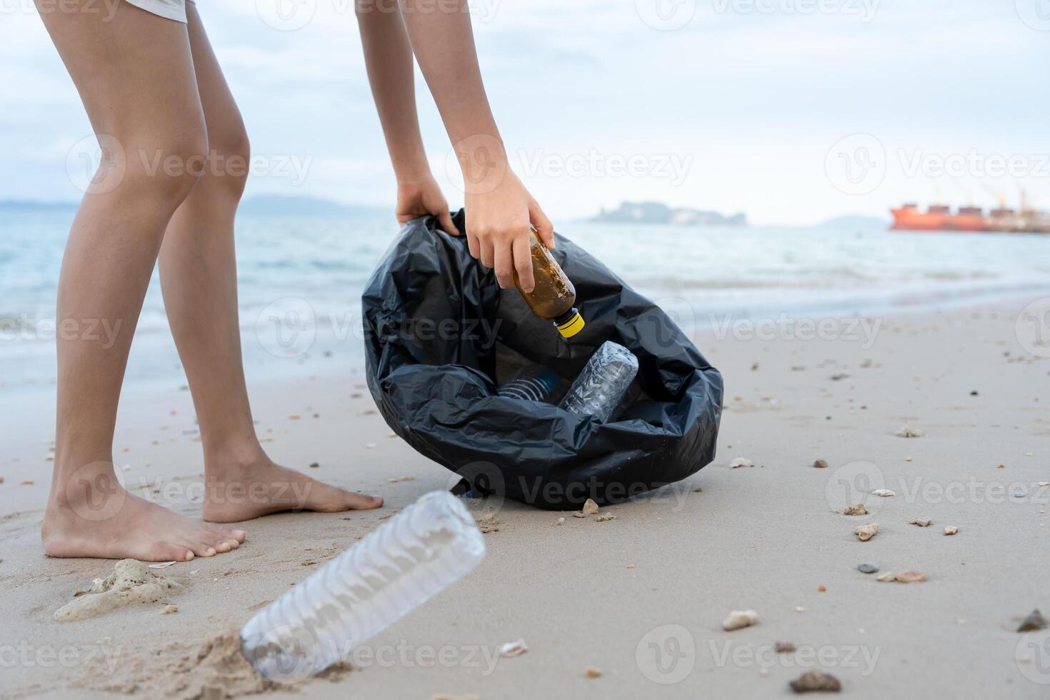 Save water. Volunteer pick up trash garbage at the beach and plastic bottles are difficult decompose prevent harm aquatic life. Earth, Environment, Greening planet, reduce global warming, Save world photo