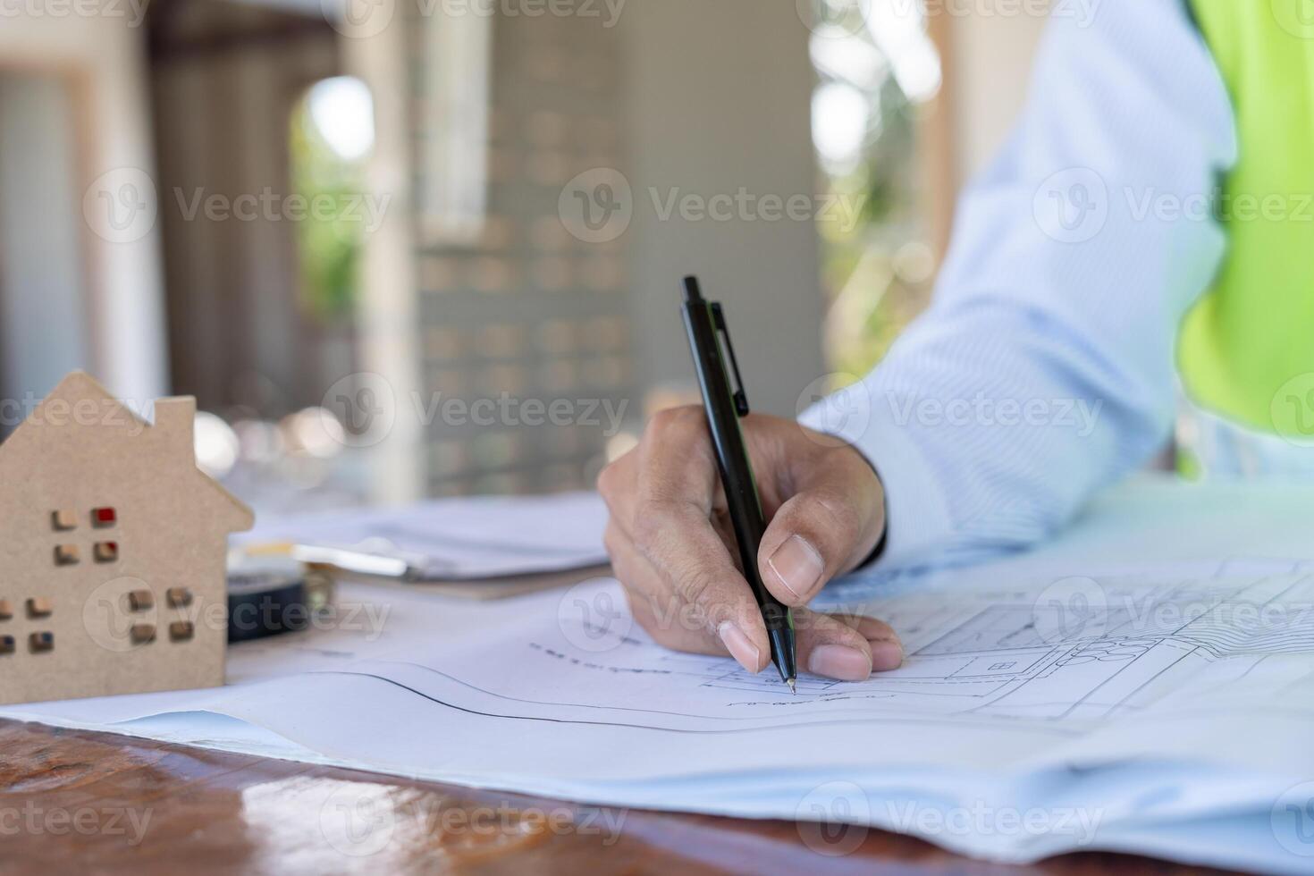 Engineers man recheck and review the blueprint of construction. Contractor inspection drawing before start project civil. Prepare construction project planning, consulting, architecture. photo