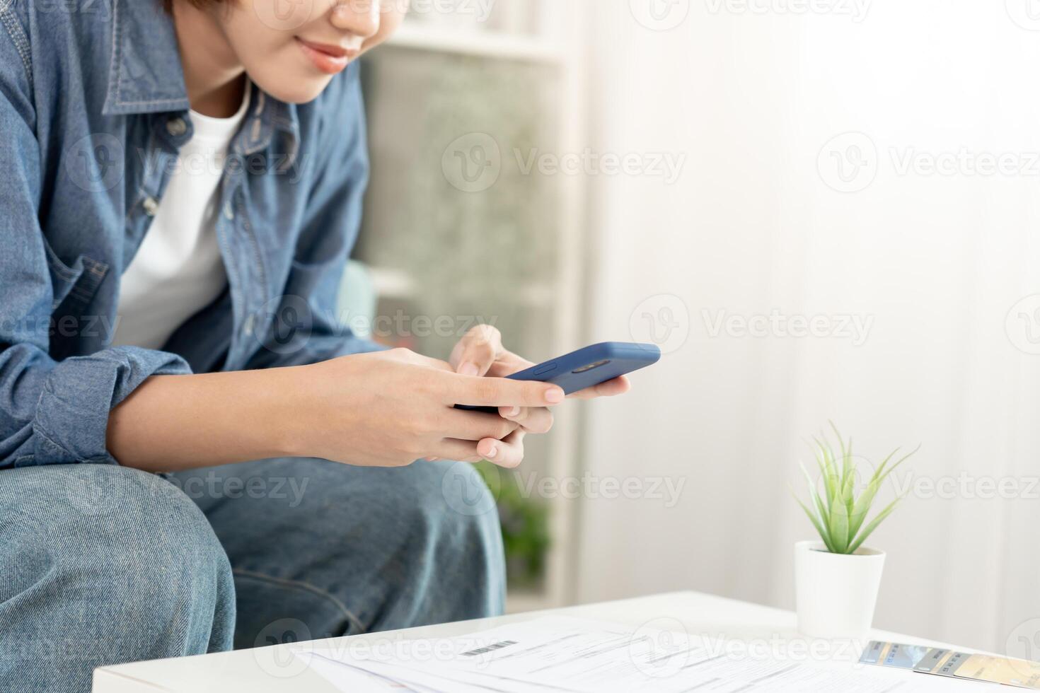 Modern woman use phone to scan barcode or QR codes to pay credit card bill after receive document invoice. payment, receive, paying electricity, digital payments without money, technology, scanning photo