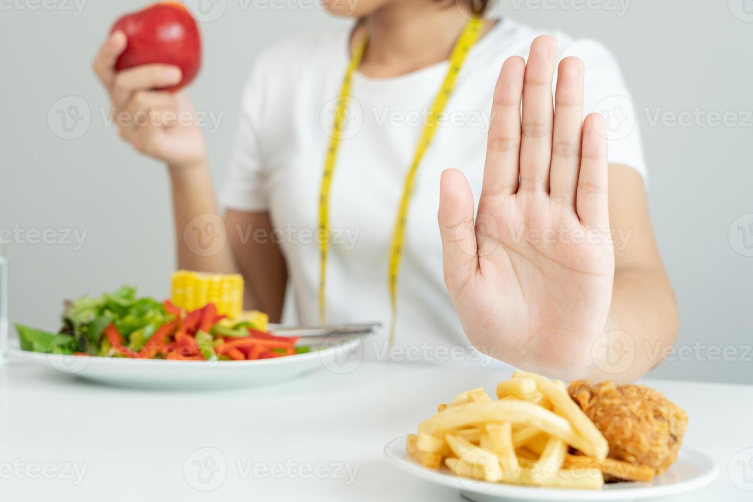 Beauty slim female body confuse French fries. Woman in restaurant achieves weight loss goal for healthy life, crazy about thinness, thin waist, nutritionist. Diet, body shape. photo