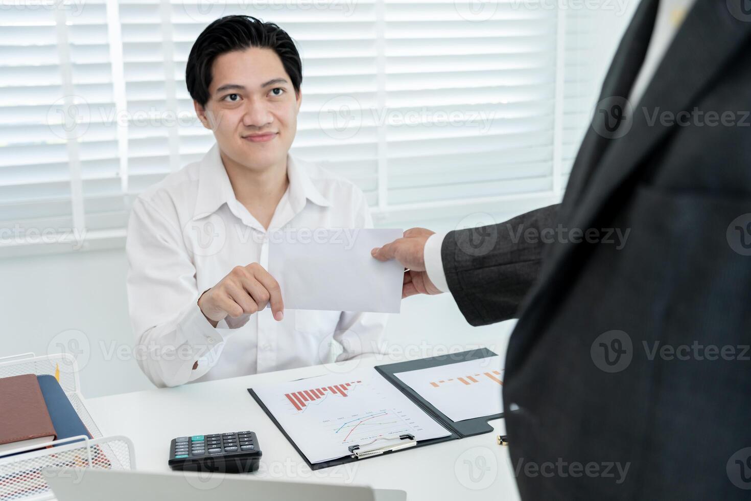 Businessmen receive salary or bonuses from management or Boss. Company give rewards to encourage work. Smiling businessman enjoying a reward at the desk in the office. photo
