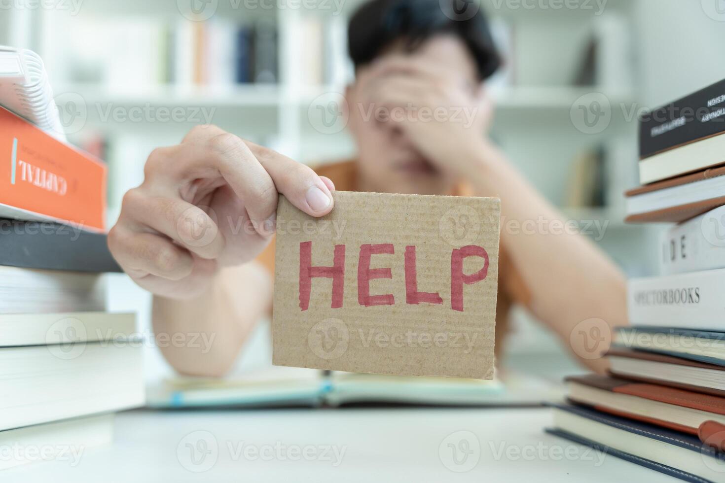 Asian student man have anxiety because of exams, male prepare for test and learning lessons in the library. stress, despair, haste, misunderstanding reading, discouraged, expectation, knowledge, tired photo
