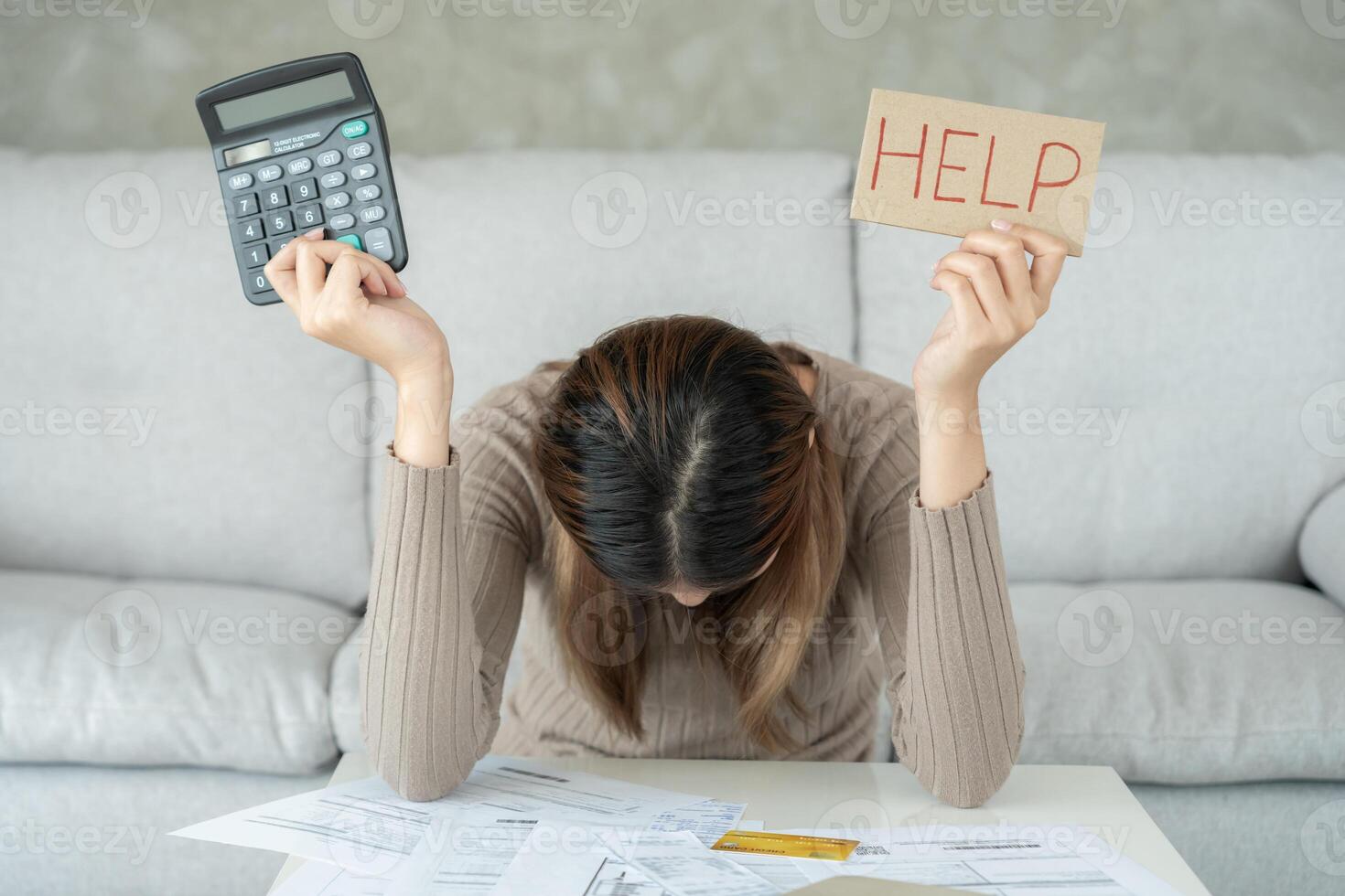 Stressed and headache asian woman with large bills or invoices no money to pay to expenses and credit card debt. shortage, Financial problems, mortgage, loan, bankruptcy, bankrupt, poor, empty wallet photo