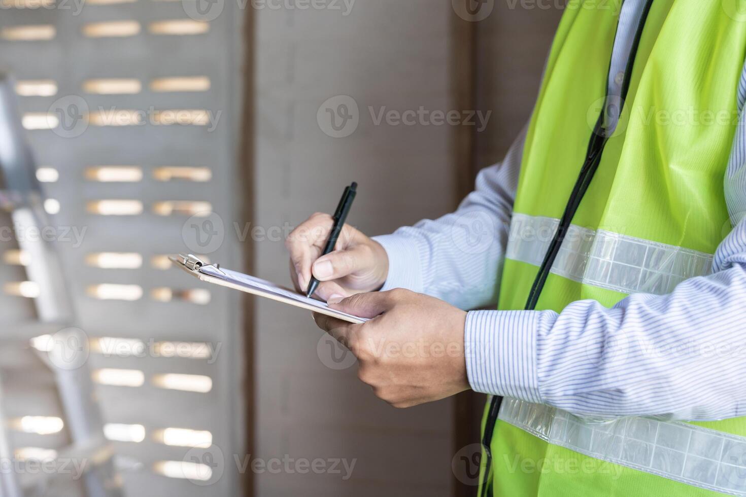 inspector or engineer is inspecting construction and quality assurance new house using a checklist. Engineers or architects or contactor work to build the house before handing it over to the homeowner photo