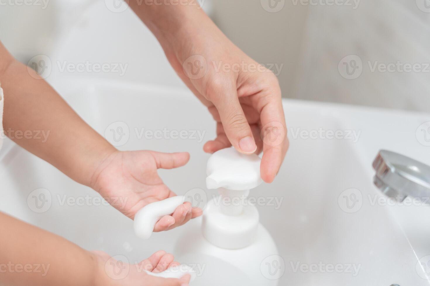 little kid hands wash with soap bubbles and rinse with clean water to prevent and stop the spread of germs after back to home, virus or covid19. Good health and good personal hygiene, virus, bacteria photo