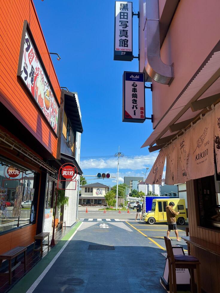 Afternoon Street Scene with City Cafe and Restaurant Signs in Japanese town, Chonburi, Thailand photo