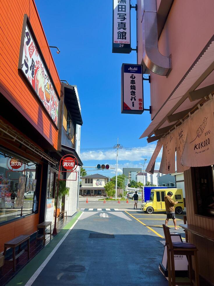 Afternoon Street Scene with City Cafe and Restaurant Signs in Japanese town, Chonburi, Thailand photo
