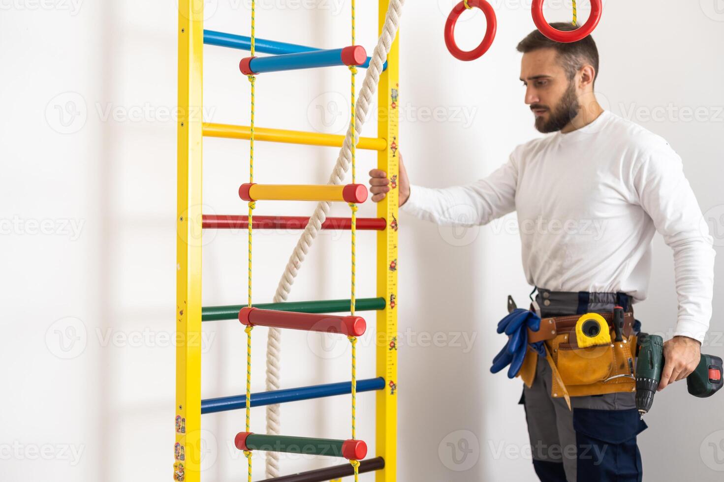 A man with instructions for assembling furniture is going to assemble in a children's bedroom photo