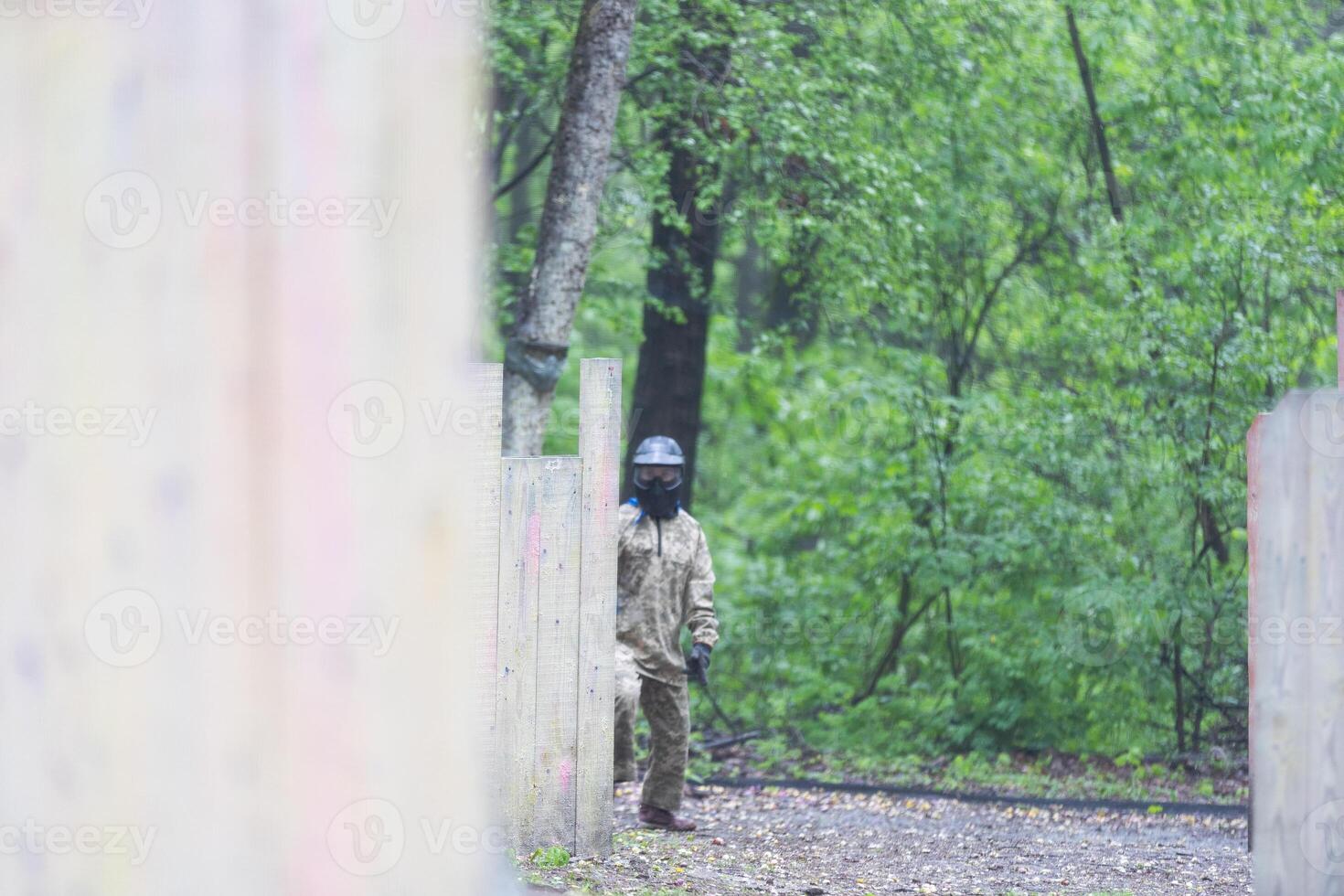 children playing paintball in the forest photo