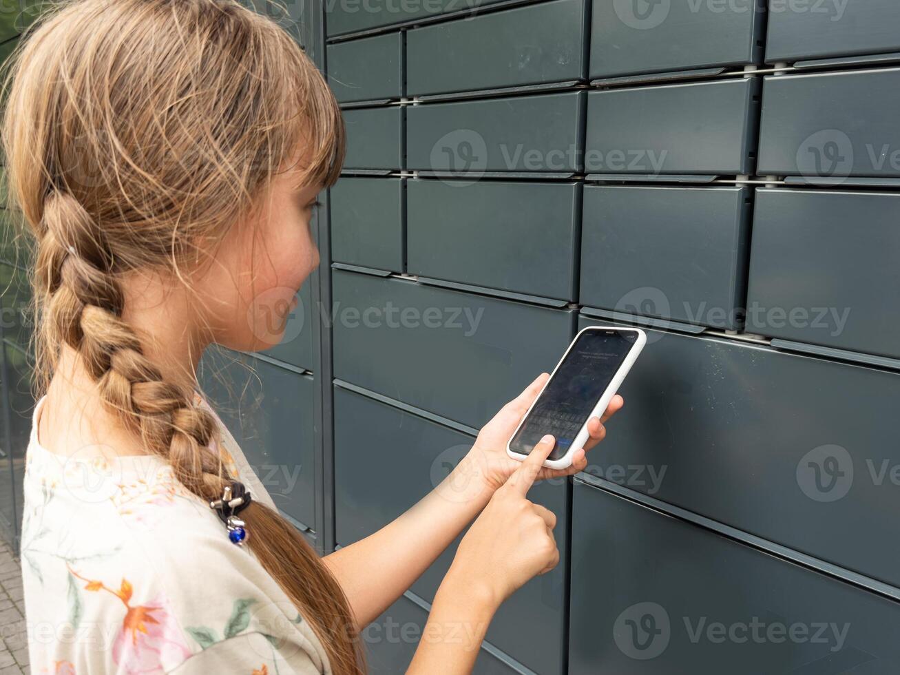 the girl opens the mailbox with a smartphone photo