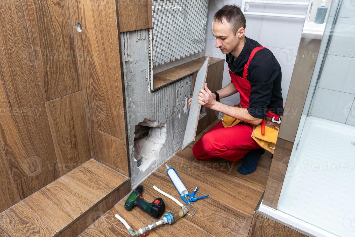 Construction man using hammer and tool while demolish wall photo