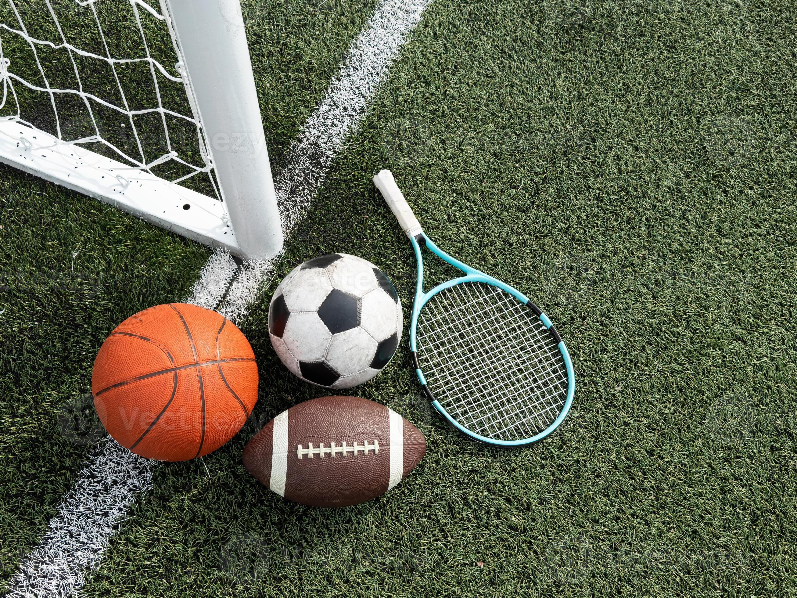 A variety of sports equipment including an american football a soccer A variety of sports equipment including an american football a soccer