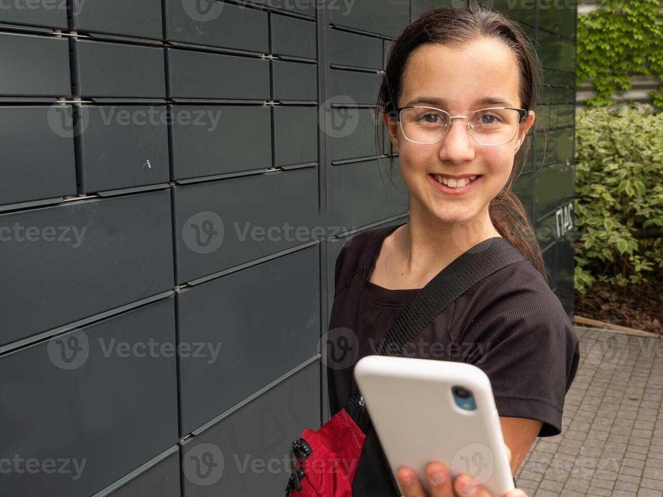 the girl using an automatic self-service terminal . Quarantine delivery, outbreak, covid-19 coronavirus in a pandemic, safety delivery photo