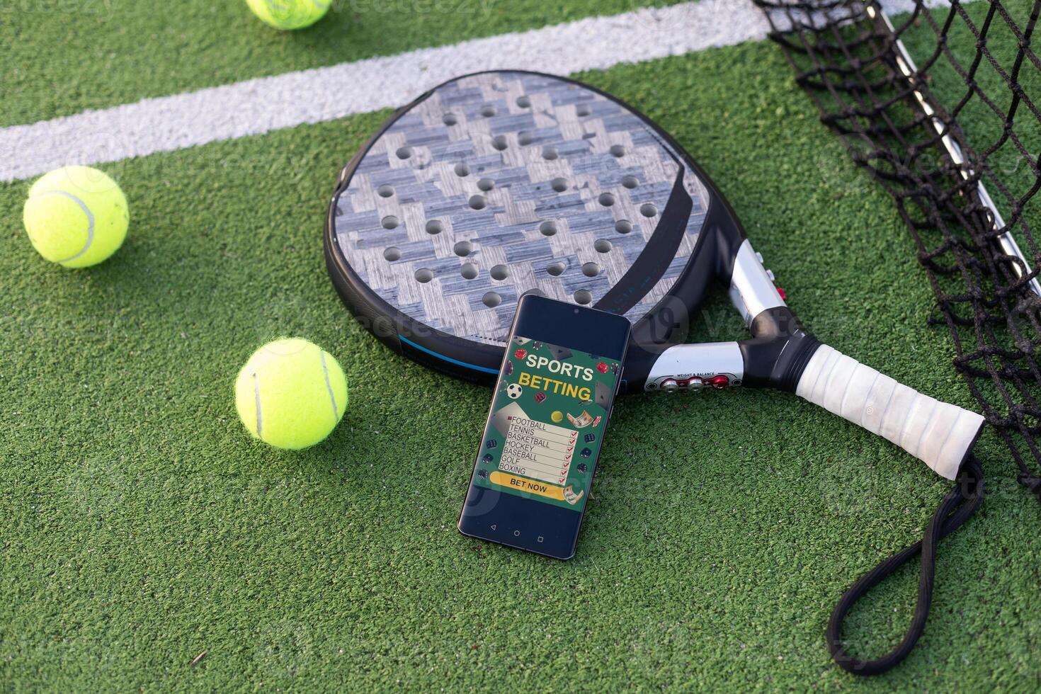 A tennis ball, a racket and a mobile phone with a put screen lie on a blue background. The concept of advertising a tennis club or ordering services. Horizontal photo
