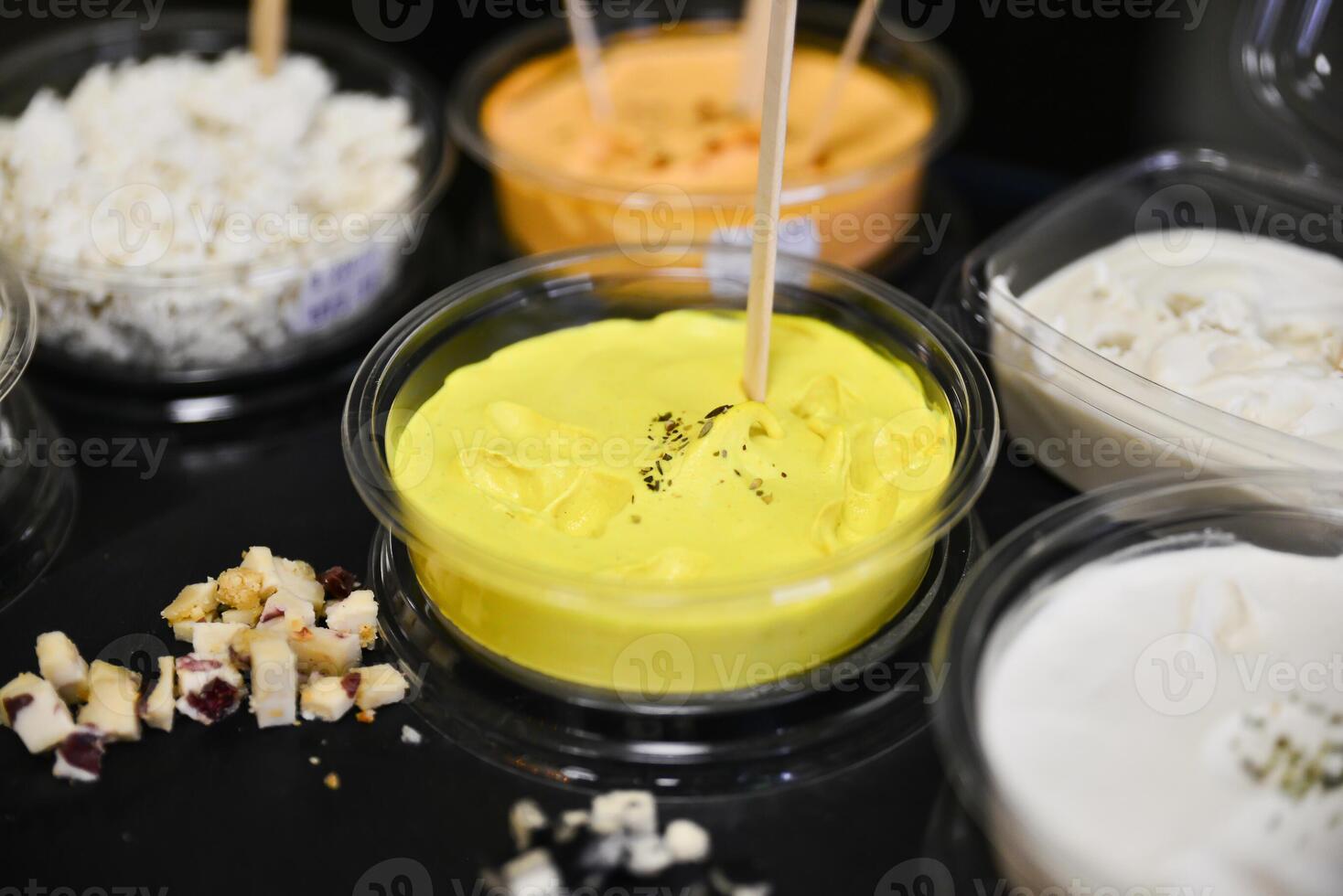 Cheese arranged on a dark table. Different sorts of cheese. Various types of cheese photo