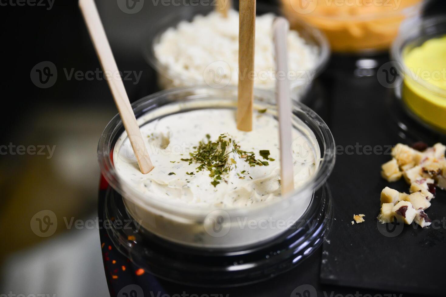 Cheese arranged on a dark table. Different sorts of cheese. Various types of cheese photo