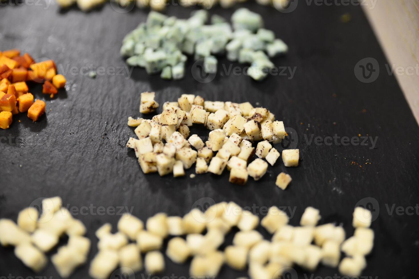 Cheese arranged on a dark table. Different sorts of cheese. Various types of cheese photo