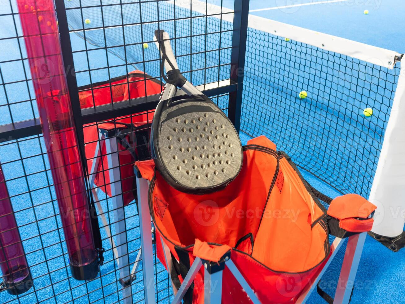 professional paddle tennis racket with natural lighting on blue background. Horizontal sport theme poster, greeting cards, headers, website and app photo