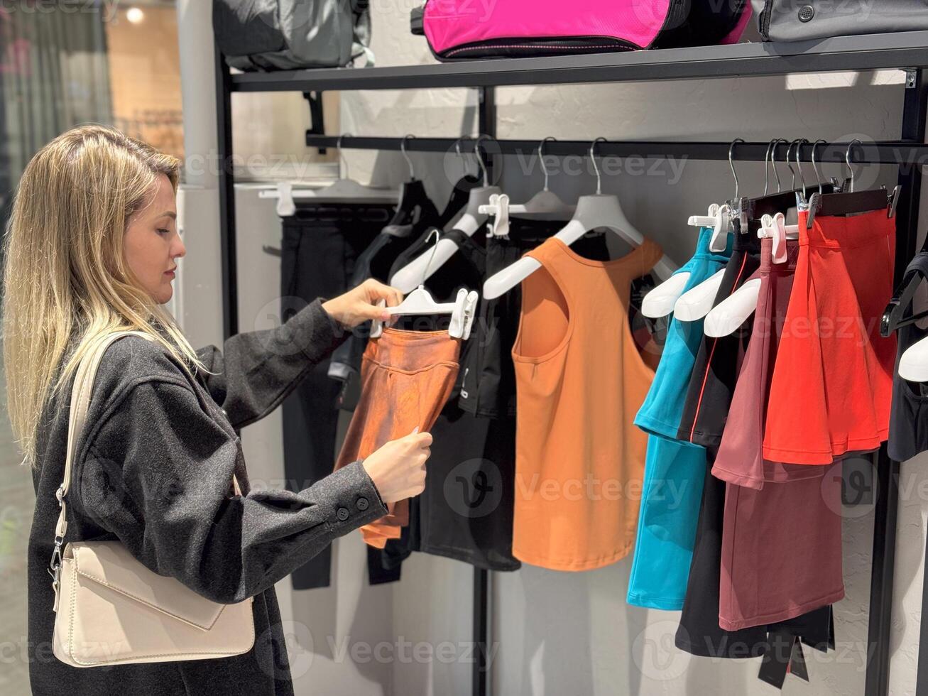 young adorable woman is choosing clothes photo