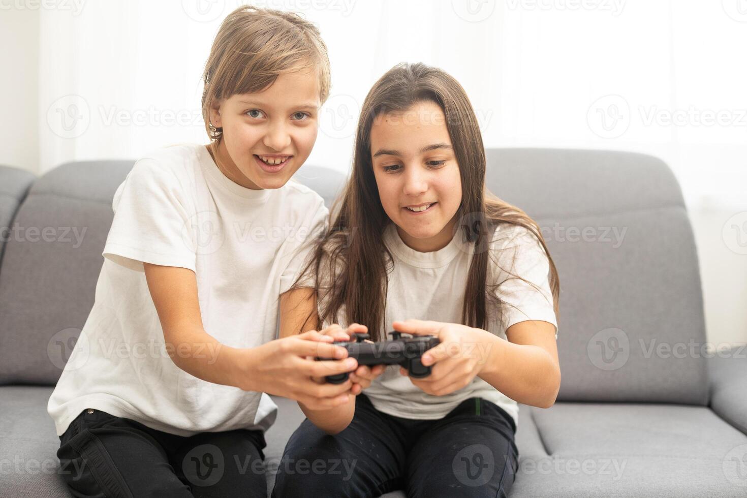 Two sisters kids playing games at home together. Happy childeren, carefree childhood concept photo