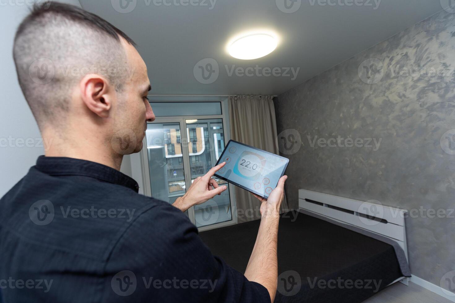 Man using smart home security system control panel photo