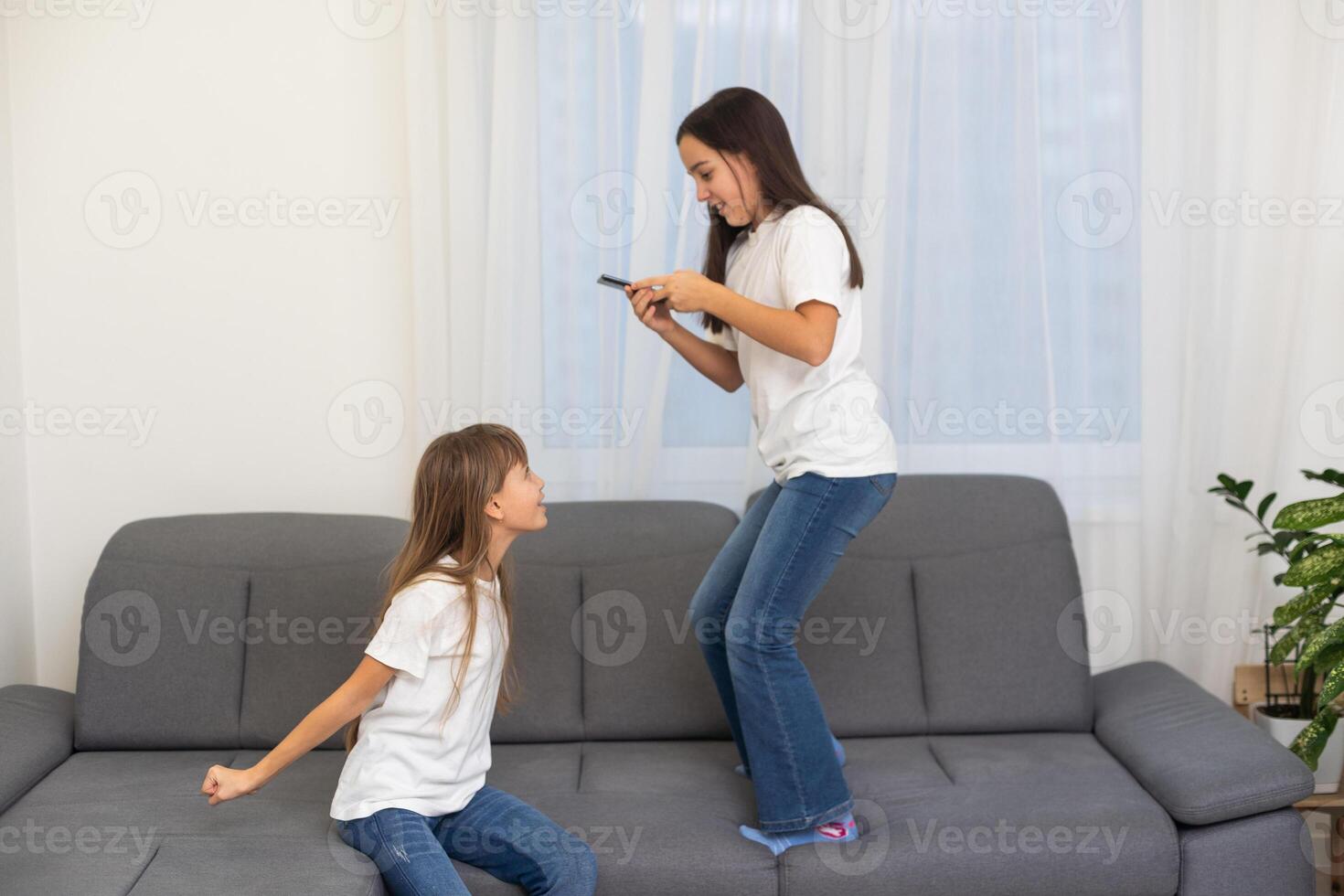 little children with a phone in their hands playing games photo