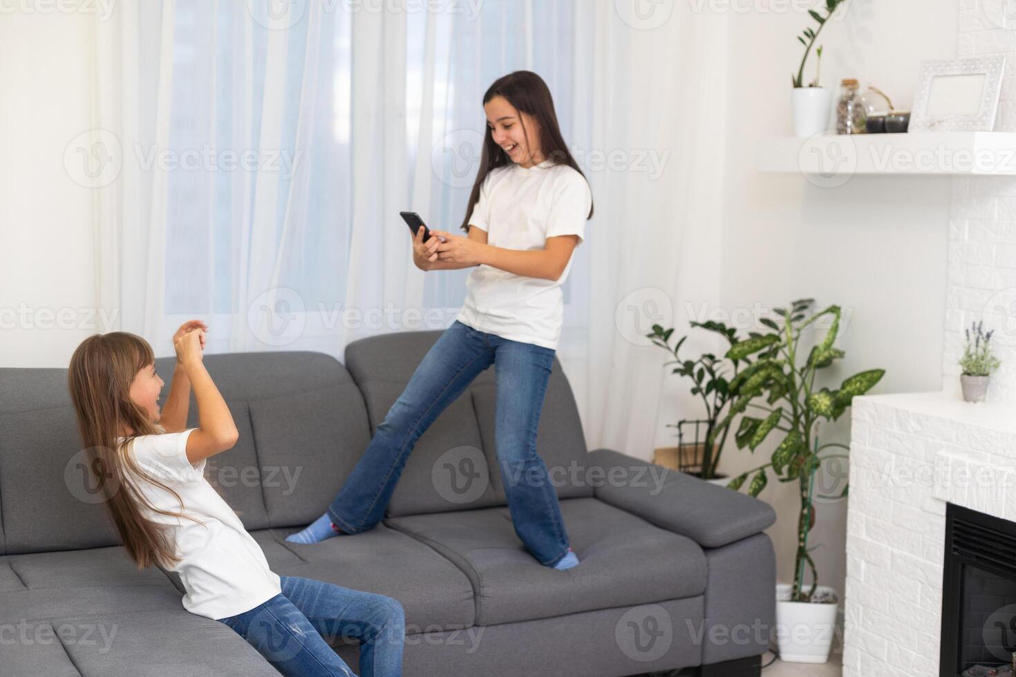 little children with a phone in their hands playing games photo