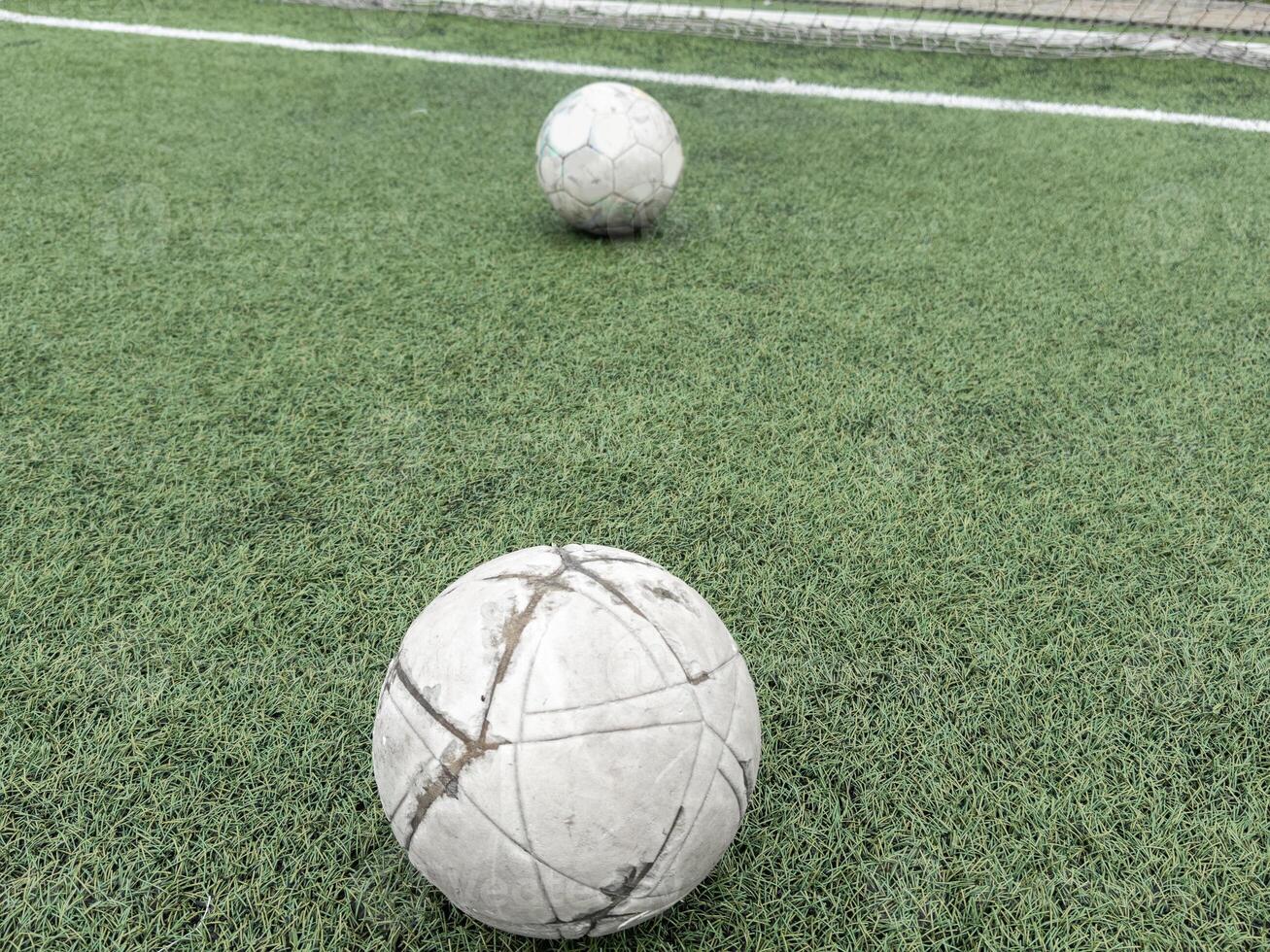 Green grass and white border lines on football ground. Soccer field on artificial turf. Artificial green grass texture. Artificial football field in an open stadium photo