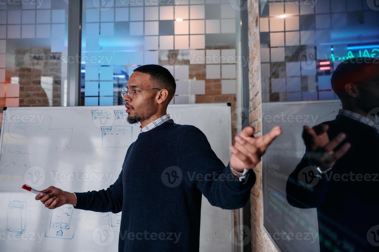 African American businessman delivers a compelling presentation of his business strategy to his colleagues, fostering collaboration and forward thinking photo