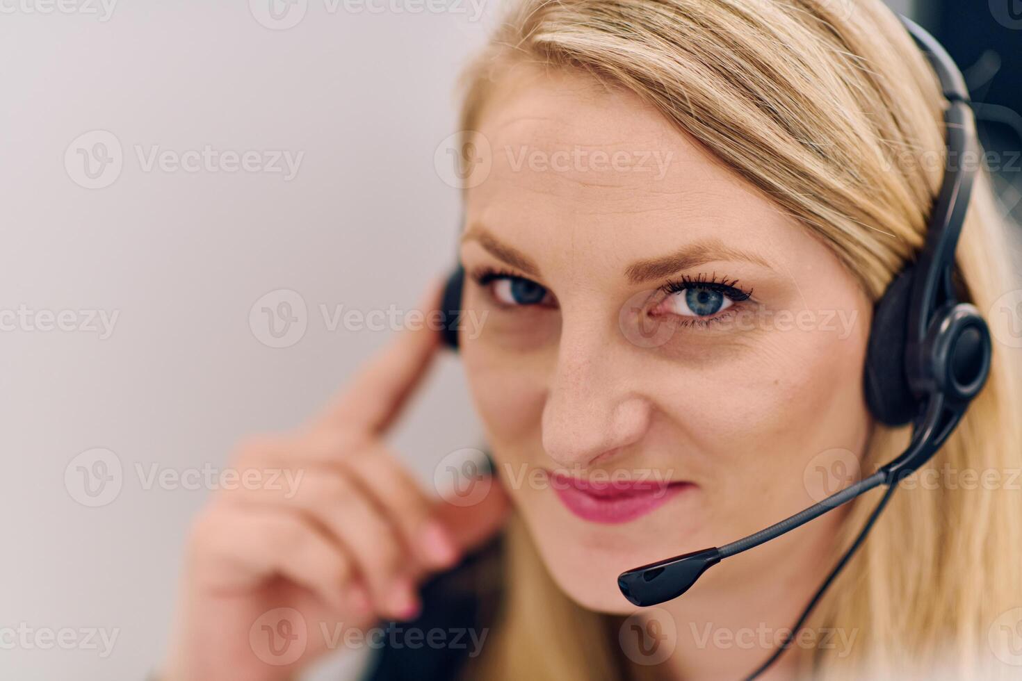 Friendly Call Center Agent Answering Incoming Calls with Headset Providing Remote Customer Service. photo