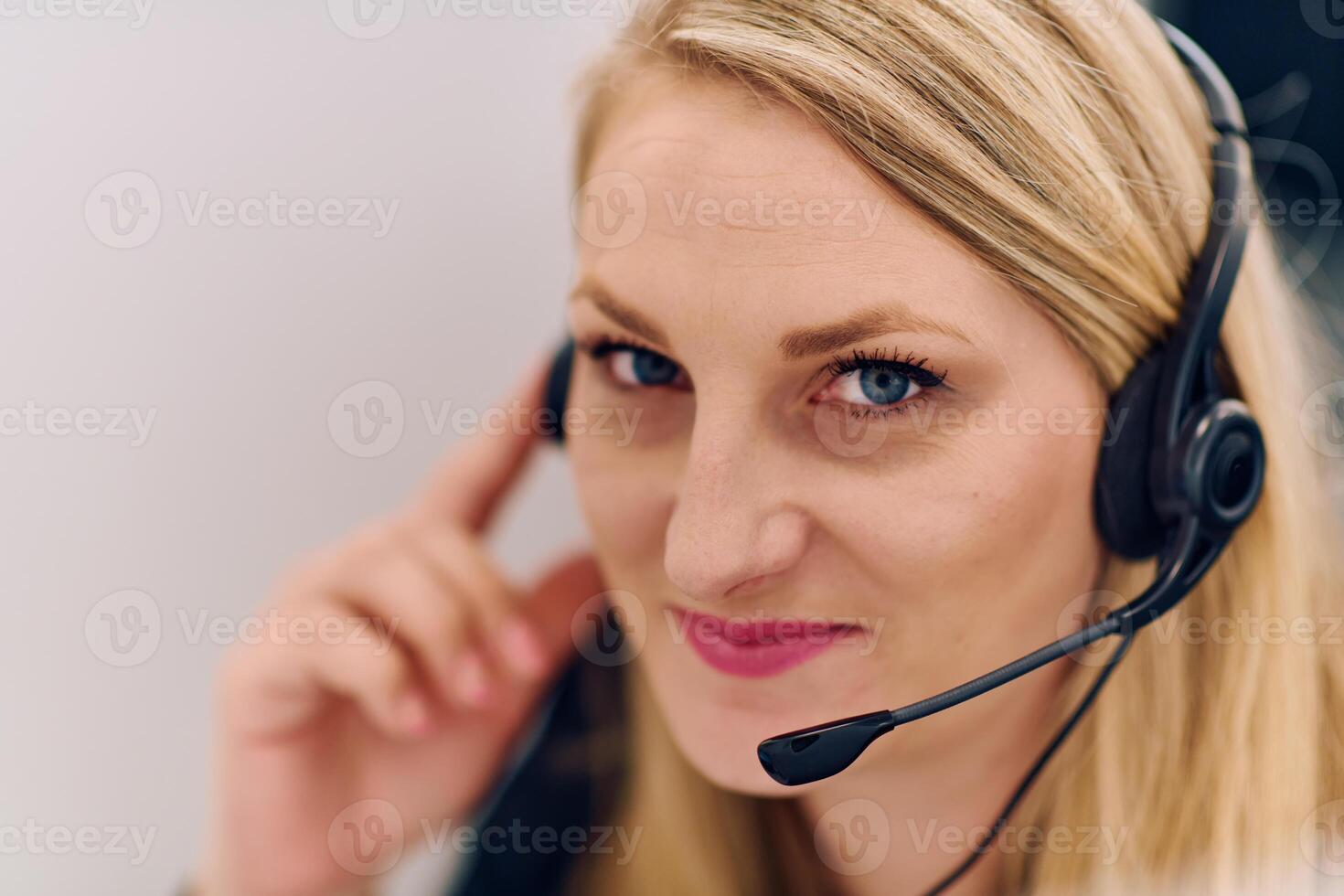Friendly Call Center Agent Answering Incoming Calls with Headset Providing Remote Customer Service. photo