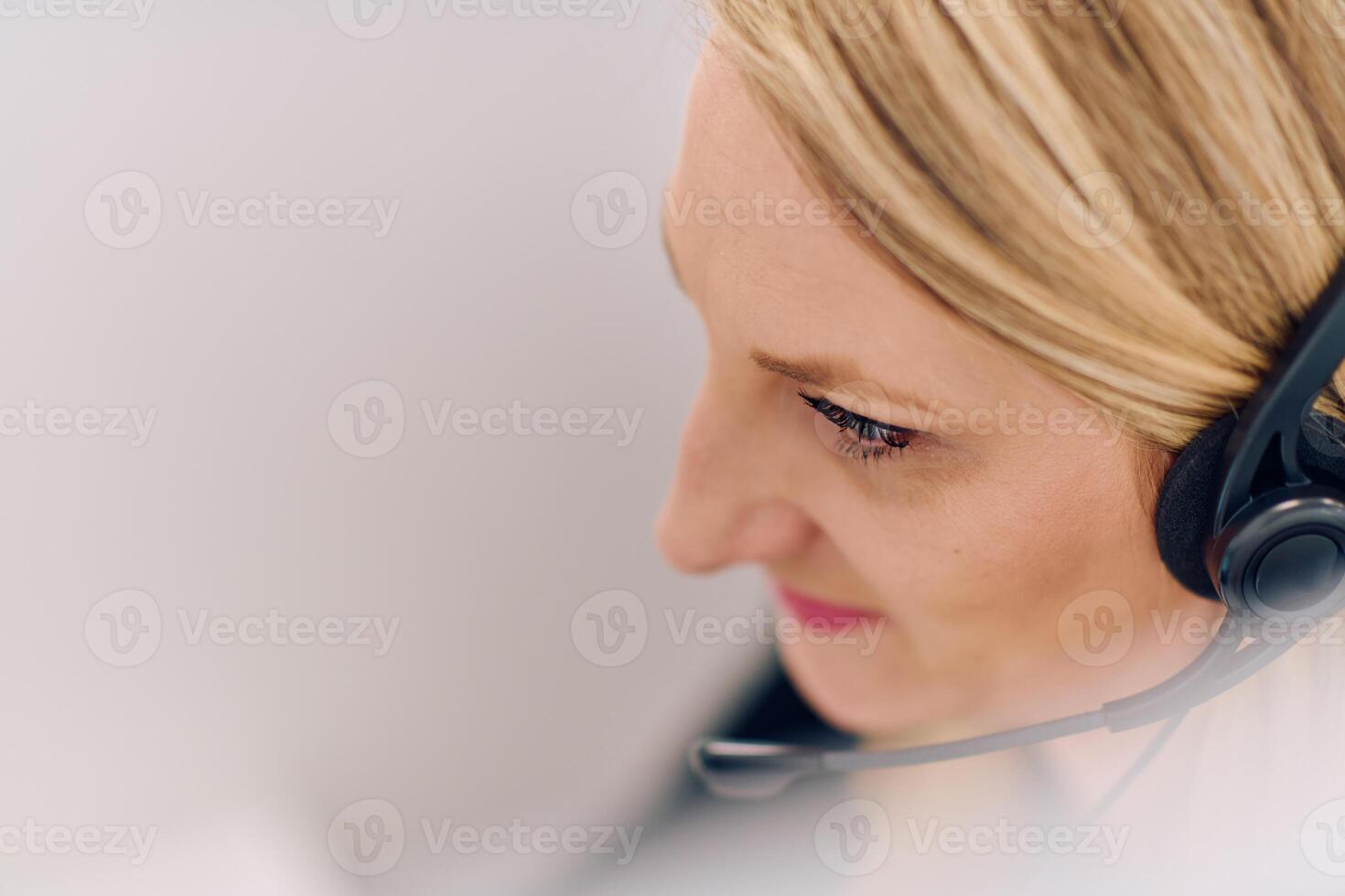 Friendly Call Center Agent Answering Incoming Calls with Headset Providing Remote Customer Service. photo