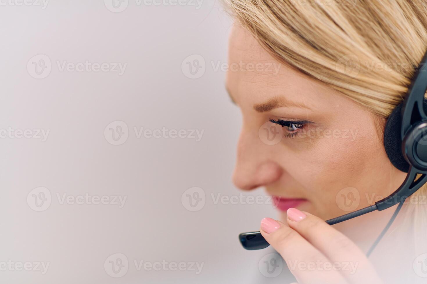Friendly Call Center Agent Answering Incoming Calls with Headset Providing Remote Customer Service. photo