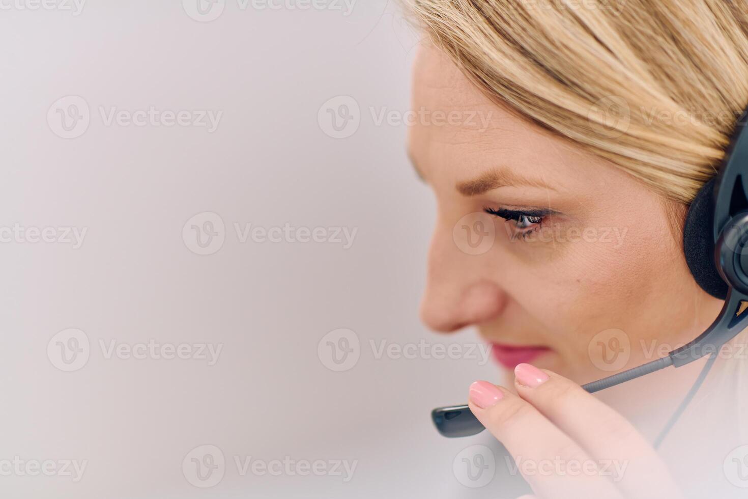 Friendly Call Center Agent Answering Incoming Calls with Headset Providing Remote Customer Service. photo