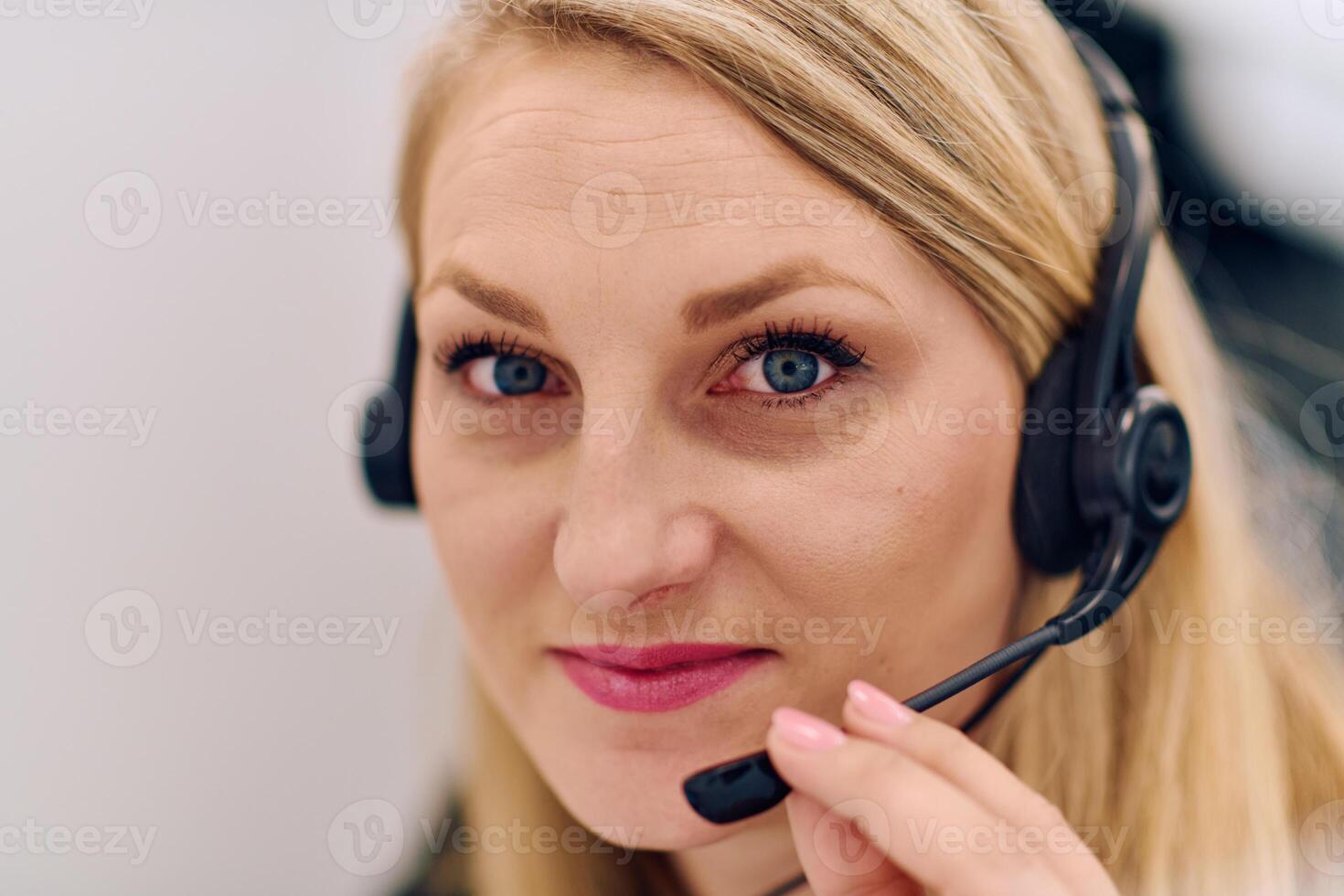 Friendly Call Center Agent Answering Incoming Calls with Headset Providing Remote Customer Service. photo