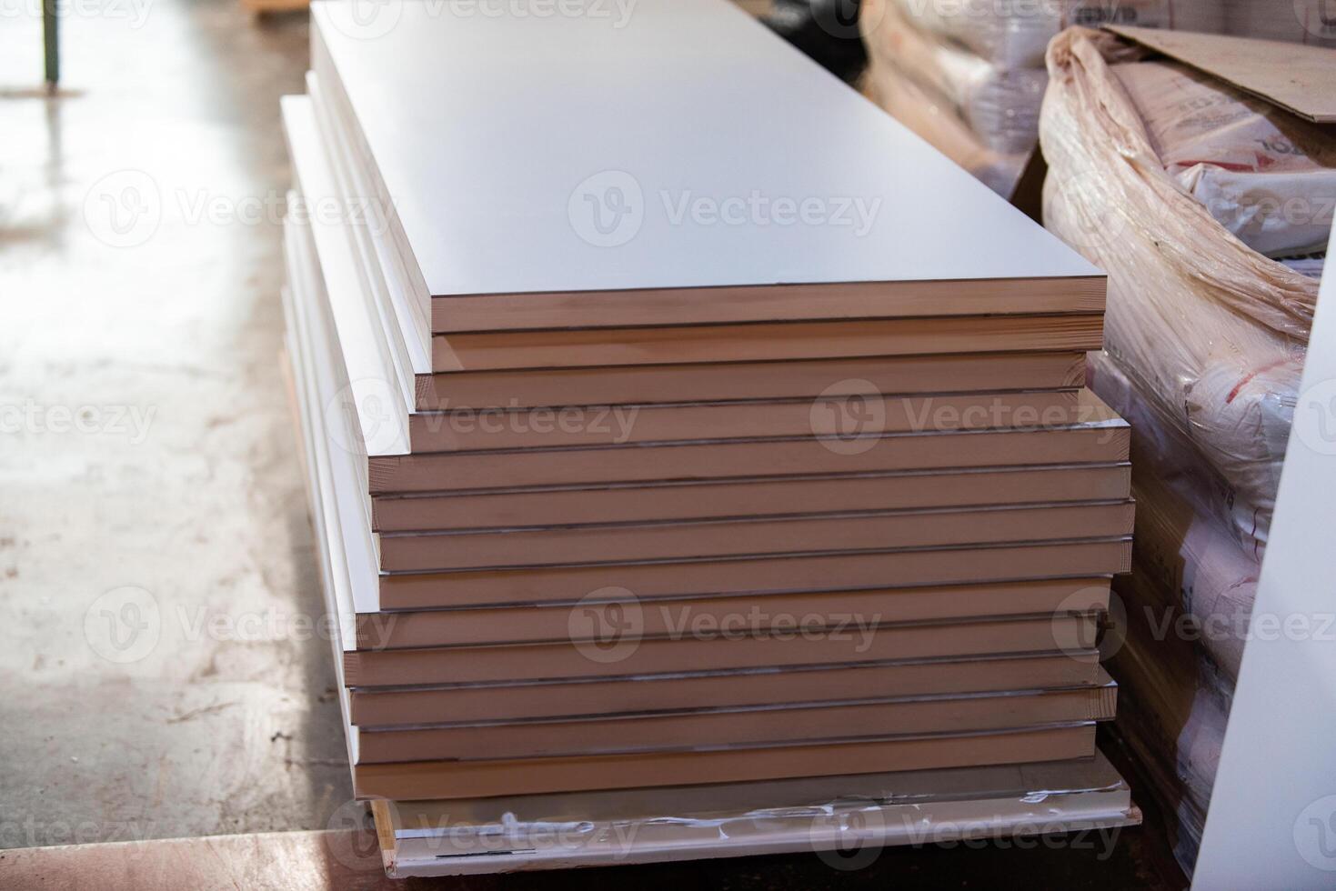 A vast warehouse in the forestry industry, showcasing a plethora of wooden products, including boards and various timber items neatly organized in storage photo