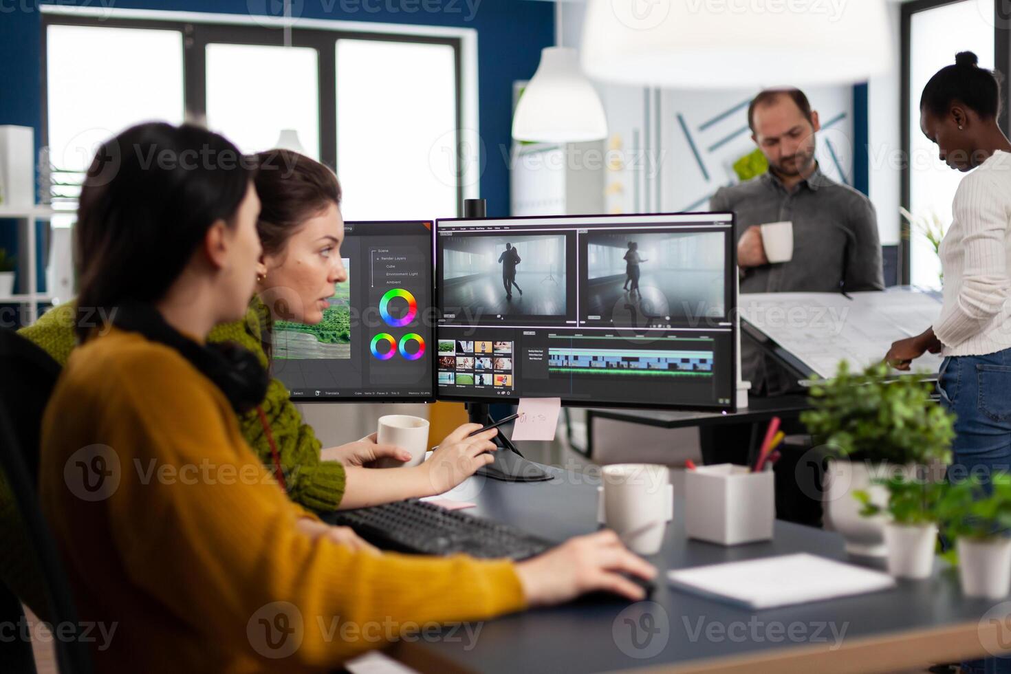 editor and sound engineer working together at project, editing audio and film footage in post production software. Women videographers processing movie montage sitting in creative agency office photo