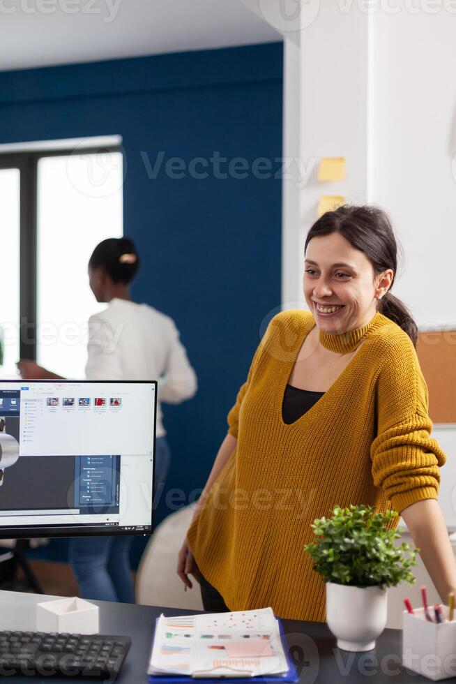 Industrial architect colleagues working and having fun sharing ideas for new mechanical project. Engineers using pc with CAD software and two monitors in start up company innovating motor prototype. photo