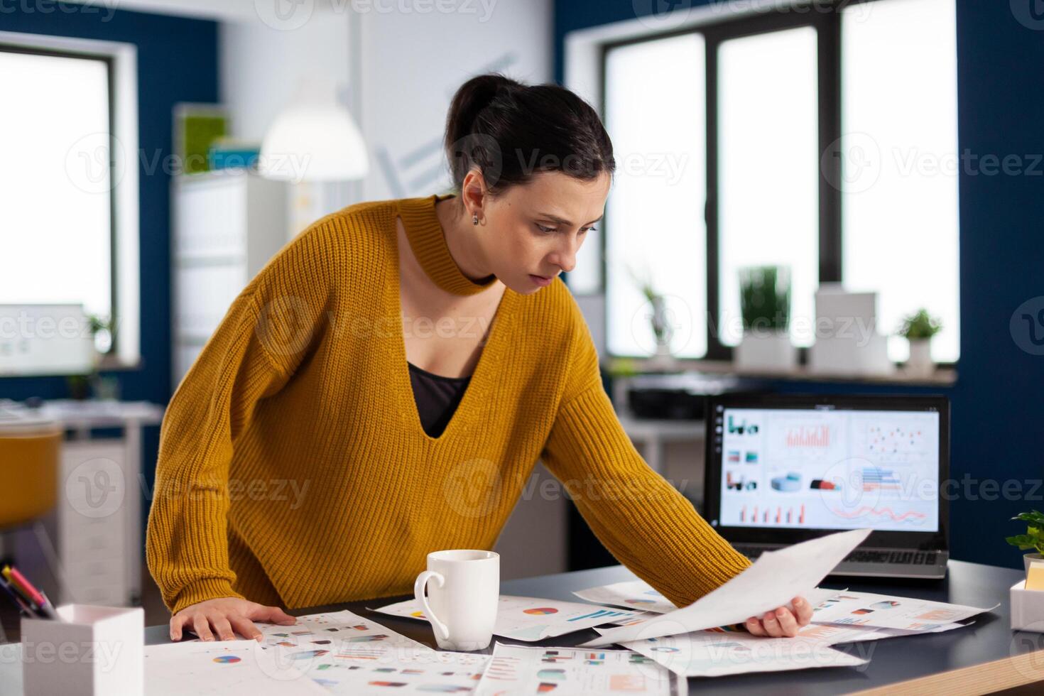 Corporate business woman reading statistics on documents paperwork Executive entrepreneur, manager leader standing working on deadline documents projects. photo