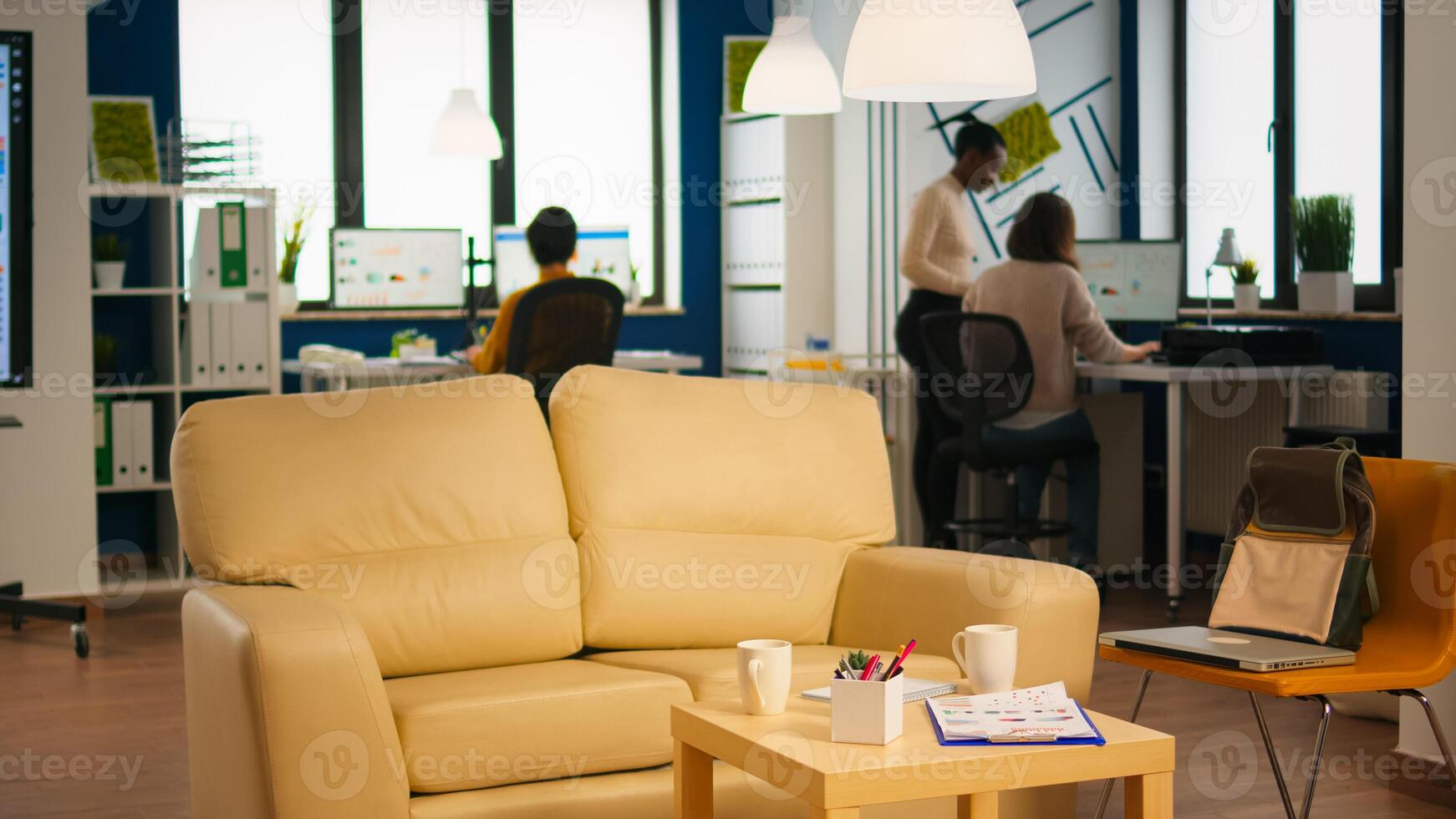 Diverse business people working in modern start up office discussing financial strategy. Multiethnic coworkers talking about startup annual reports of company in modern business office photo