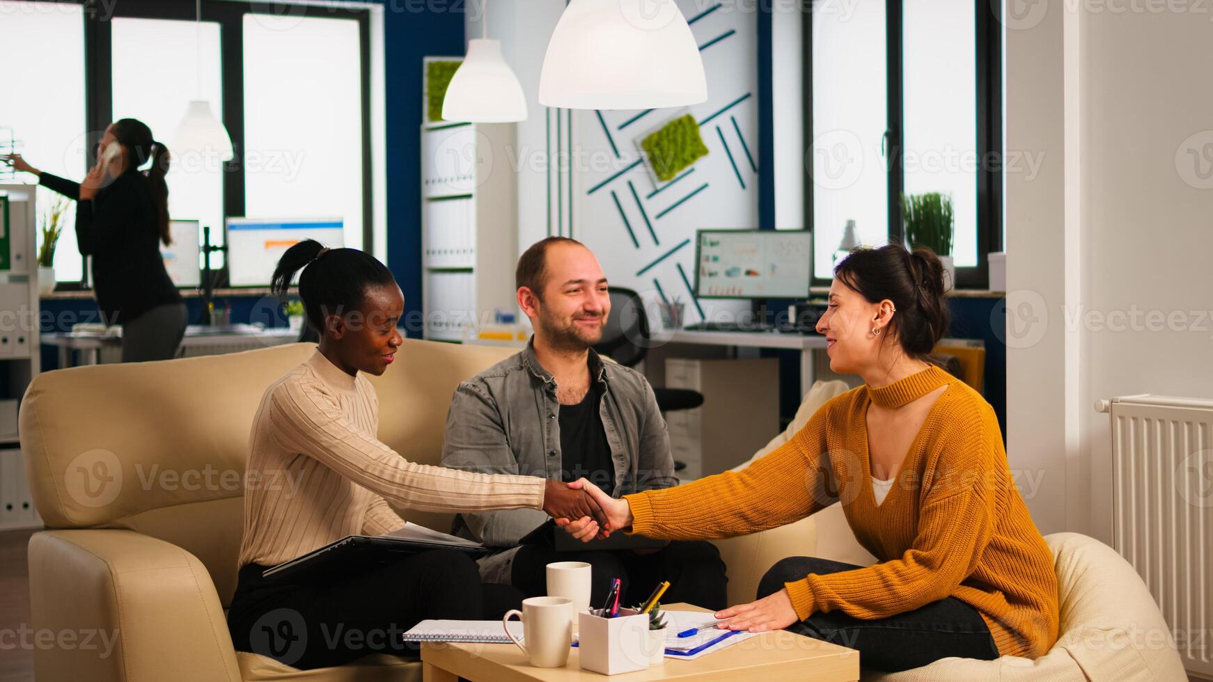 Diverse business people shaking hands, consultant greeting international clients with handshake and planning partnership deal with executive meeting shareholders in start up corporate office photo