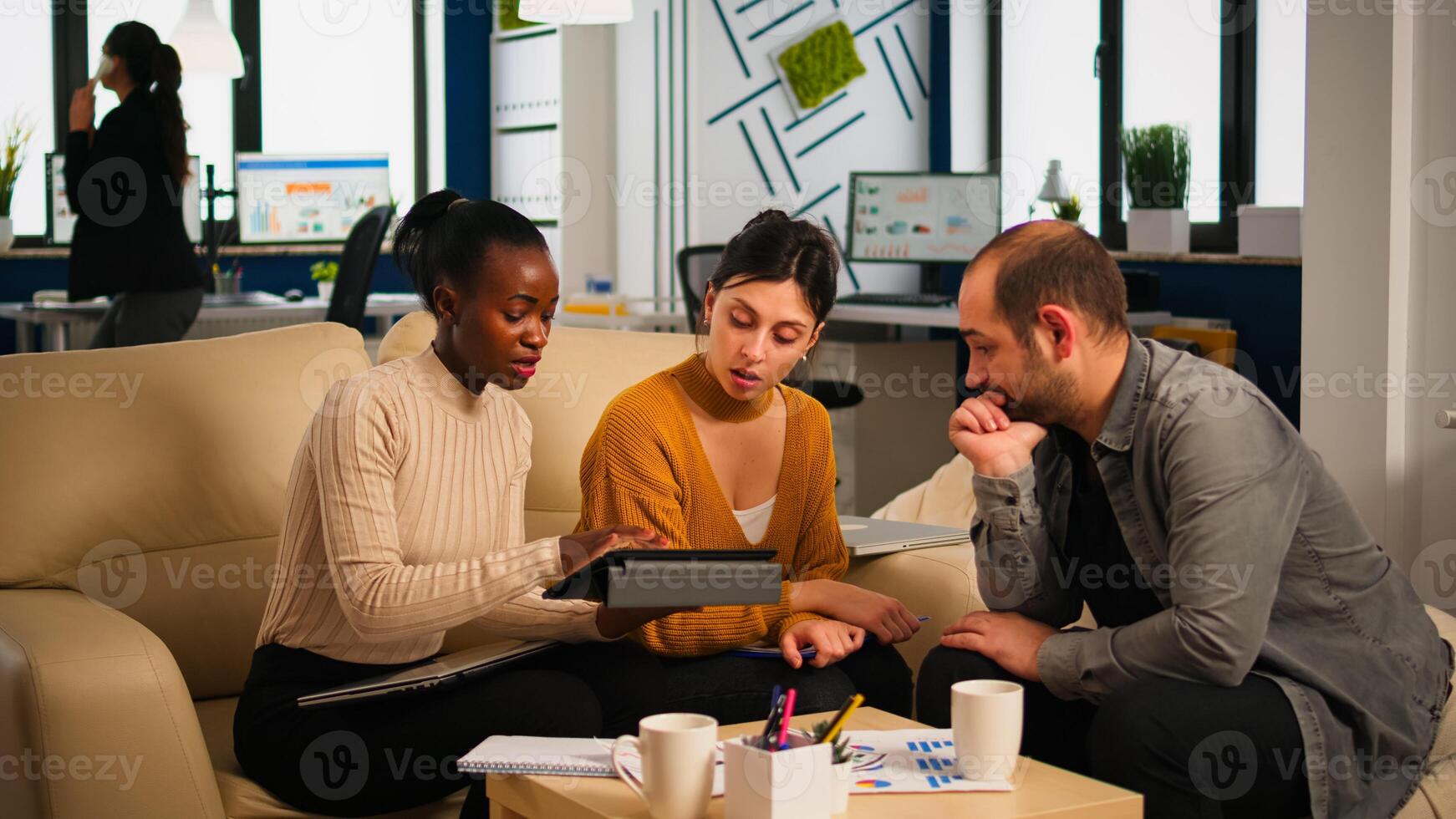 Diverse colleagues during business meeting with african american woman manager brainstorming company development plan. Employees in modern start up office discussing project strategy sharing ideas photo