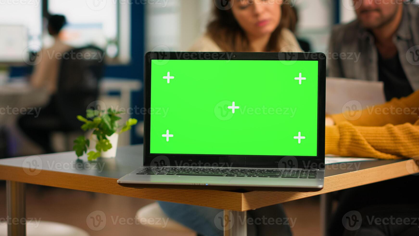 Businesspeople analysing annual financial reports sitting at desk in back of laptop with green screen monitor. Leader explainig project strategy using greenscreen pc with chroma key display. photo