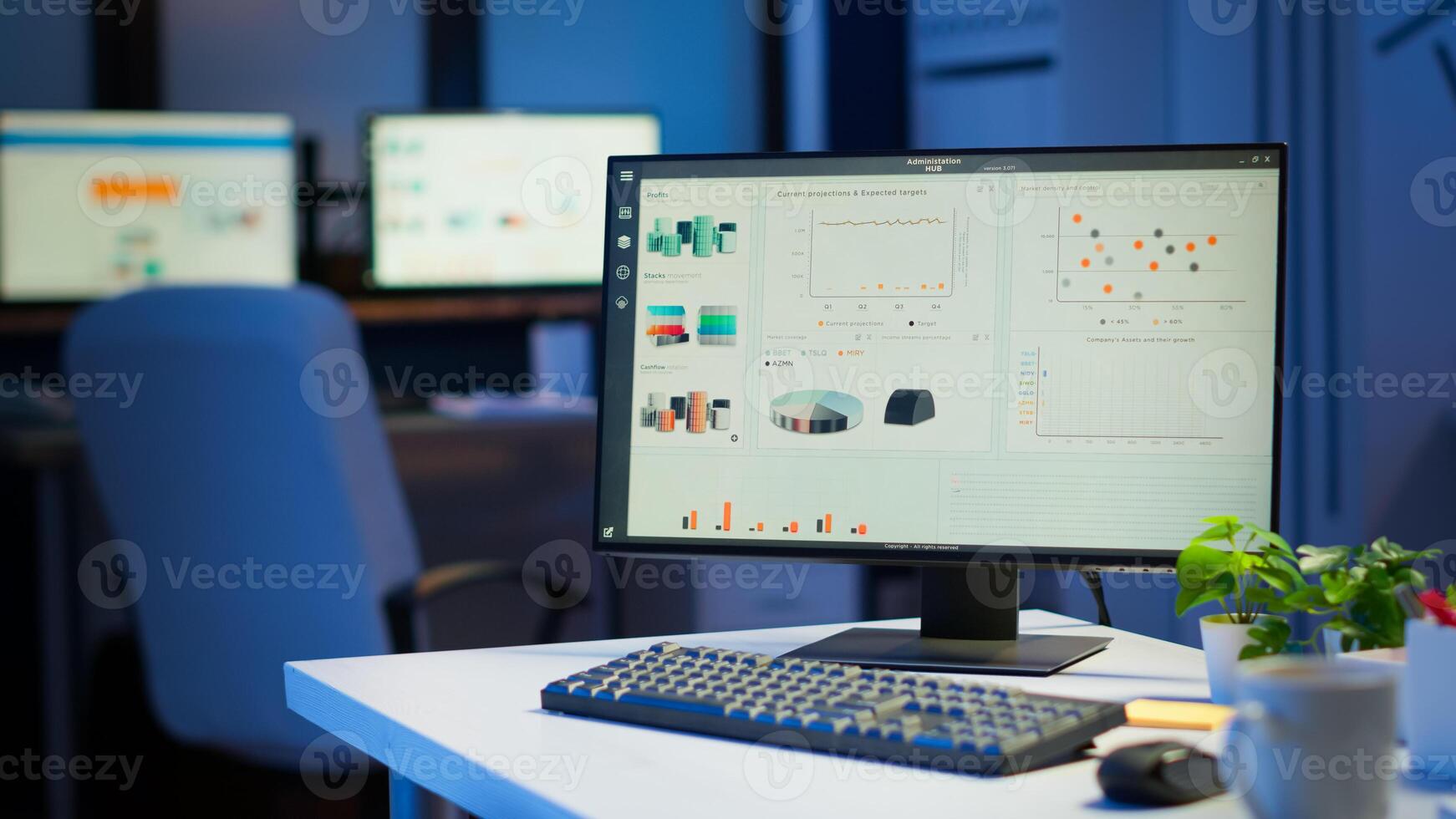 Financial company with nobody in it, place of work startup, workplace indoors concept. Interior of empty start up business office with modern design during night with graphics running on the desktop. photo