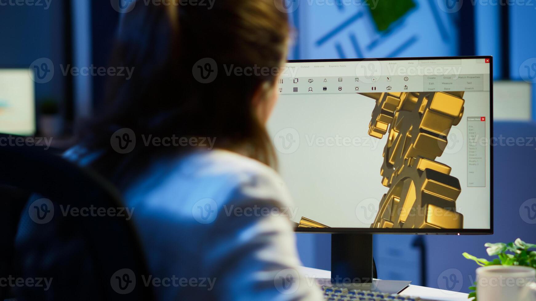 Focused woman architect working at new project using computer doing overtime at night sitting at desk in start-up office. Industrial female engineer studying on pc showing cad software in midnight photo
