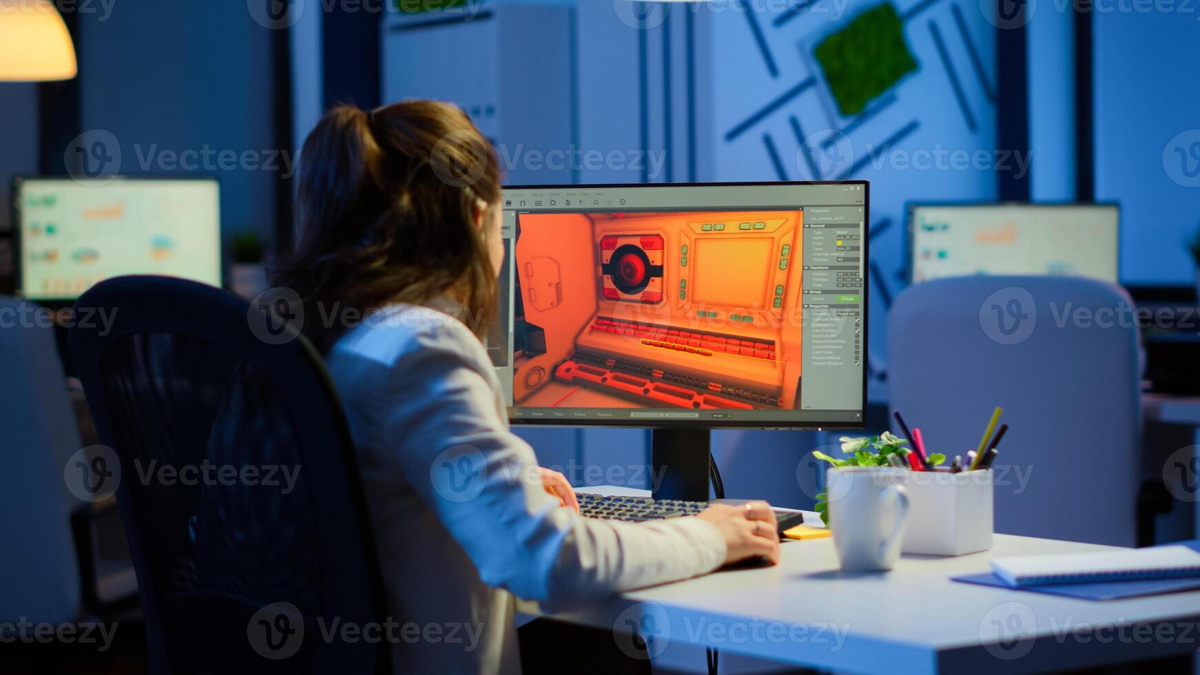 Woman game sotware developer testing new game overtime at night in start up creative agency company. Tired worker developing new online games on pc with modern technology photo
