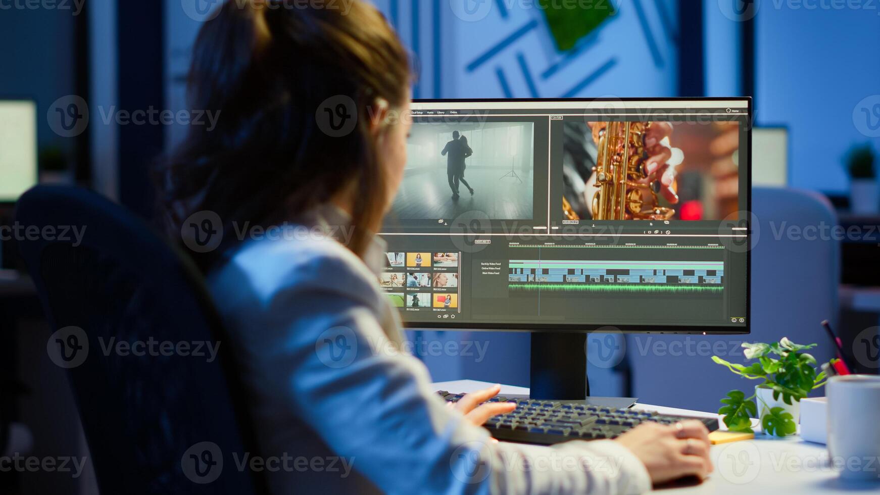 editor working at night at new project editing audio film montage sitting in start-up business office. Woman content creator using professional computer, modern technology, network wireless photo