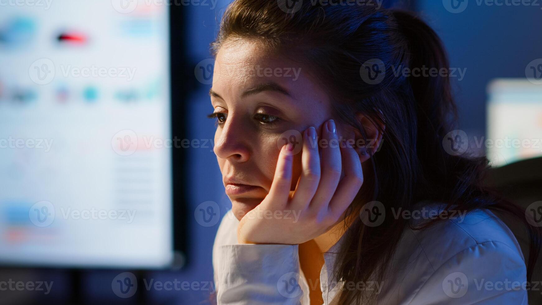 Businesswoman who worked until midnight on project falling asleep in front of laptop in start up company office, resting on hand with closed eyes. Employee using technology network doing overtime photo