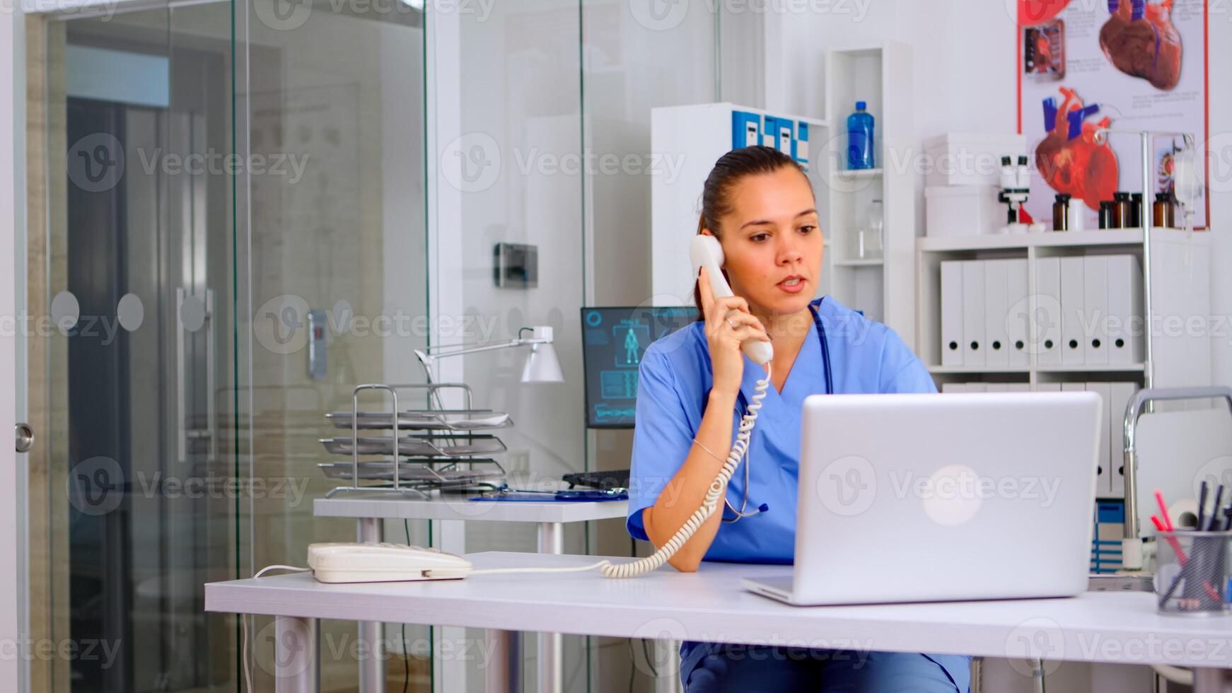 Medical practitioner talking with patient on phone from hospital office checking appointment. Health care physician in medicine uniform, receptionist doctor assistant helping with telehealth communication photo