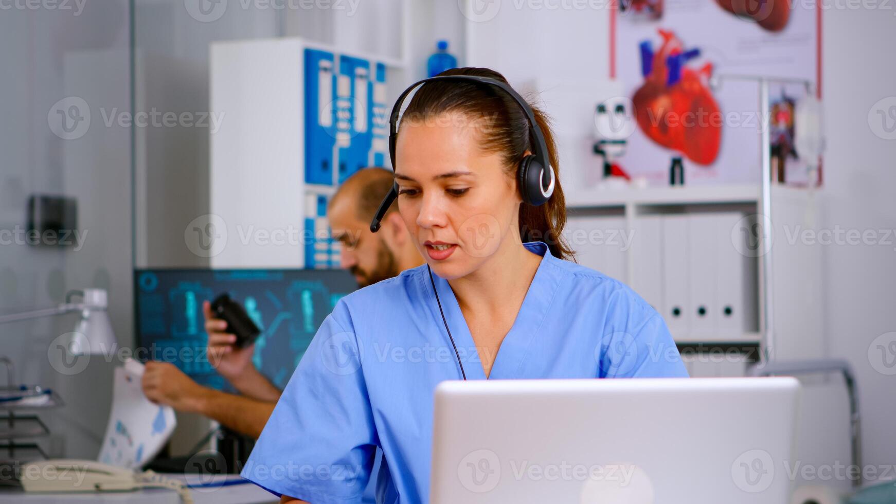Specialist doctor nurse with headphones checking appointment during telehealth communication in hospital. Healthcare physician in medicine clinic, receptionist doctor assistant helping with concultation photo